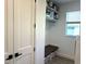 Laundry room featuring a bench, overhead storage and modern appliances at 2750 W Marion Ave, Punta Gorda, FL 33950