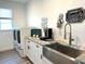 Well-organized laundry room with sink, modern appliances and granite countertops at 2750 W Marion Ave, Punta Gorda, FL 33950