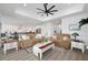 Bright and open living room showcasing modern ceiling fan and decor, seamlessly connecting to the kitchen at 2750 W Marion Ave, Punta Gorda, FL 33950