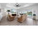 Comfortable living room featuring recliners, a ceiling fan, and sliding glass doors leading to the pool at 2750 W Marion Ave, Punta Gorda, FL 33950