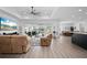 Open-concept living area with access to the dining room, featuring neutral tones, and pool views at 2750 W Marion Ave, Punta Gorda, FL 33950