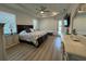 Spacious main bedroom with an ensuite bathroom, fan, and light wood-look flooring at 2750 W Marion Ave, Punta Gorda, FL 33950
