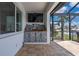 The outdoor space has a large cabinet, TV, tile flooring and is perfect for entertaining at 2750 W Marion Ave, Punta Gorda, FL 33950