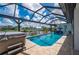 Gorgeous pool area with an enclosed screen, a nearby hot tub, and relaxing lounge chairs at 2750 W Marion Ave, Punta Gorda, FL 33950