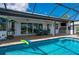 Screened in pool and patio featuring ample seating and an outdoor kitchen at 2750 W Marion Ave, Punta Gorda, FL 33950