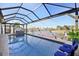 Inviting screened-in pool area with comfortable lounge chairs and canal view at 2750 W Marion Ave, Punta Gorda, FL 33950