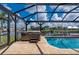 Relaxing pool area with an enclosed screen and a nearby hot tub, perfect for entertainment at 2750 W Marion Ave, Punta Gorda, FL 33950