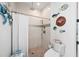Bright, updated shower with tiled walls and floor, rain shower head, and coastal decor at 2750 W Marion Ave, Punta Gorda, FL 33950