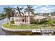 Two-story house with balconies, lush landscaping, and private boat dock at 3324 Antigua Dr, Punta Gorda, FL 33950