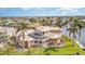 Canal-front home boasting a large pool and screened enclosure, surrounded by palm trees at 3324 Antigua Dr, Punta Gorda, FL 33950
