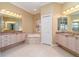 Bathroom with double vanity, corner tub, and neutral tile at 3324 Antigua Dr, Punta Gorda, FL 33950