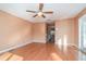 Light-filled bedroom with hardwood floors and access to hallway at 3324 Antigua Dr, Punta Gorda, FL 33950