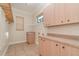 Laundry room with built-in cabinets and tile flooring at 3324 Antigua Dr, Punta Gorda, FL 33950