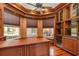 Home office with built-in cabinetry, hardwood floors and large windows at 3324 Antigua Dr, Punta Gorda, FL 33950