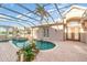 Relaxing kidney-shaped pool with spa and screened enclosure at 3324 Antigua Dr, Punta Gorda, FL 33950