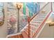 Elegant staircase with custom wall mural and hardwood floors at 3324 Antigua Dr, Punta Gorda, FL 33950