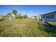 Large backyard with a swing set, slide, and open grassy area at 3355 Elkcam Blvd, Port Charlotte, FL 33952