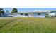 Cute light blue house with a large grassy yard at 3355 Elkcam Blvd, Port Charlotte, FL 33952