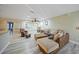 Living room with L-shaped sectional sofa and hardwood floors at 3355 Elkcam Blvd, Port Charlotte, FL 33952