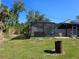 Backyard with covered patio and a rusted barrel at 430 Hunter St, Punta Gorda, FL 33980