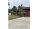 Long driveway leading to a house with a garage at 5188 Balmor Ter, North Port, FL 34288