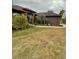 Gray house with red trim, lush landscaping, and a paved walkway at 5188 Balmor Ter, North Port, FL 34288