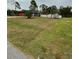 Single-story home with a large grassy front yard and a fenced-in backyard at 5188 Balmor Ter, North Port, FL 34288