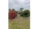Landscaped front yard with vibrant flowers and a concrete driveway at 5188 Balmor Ter, North Port, FL 34288