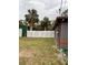 Side yard with a privacy fence and green metal shed at 5188 Balmor Ter, North Port, FL 34288