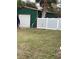 Green metal storage shed with a roll-up door at 5188 Balmor Ter, North Port, FL 34288