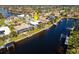 Aerial view of canal-front home with private dock and solar panels at 525 Madrid Blvd, Punta Gorda, FL 33950