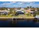 Aerial view of waterfront home with private dock and solar panels at 525 Madrid Blvd, Punta Gorda, FL 33950