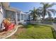 Landscaped backyard with red chairs and canal view at 525 Madrid Blvd, Punta Gorda, FL 33950