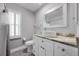 Bathroom with white cabinets, granite countertop, and patterned floor at 525 Madrid Blvd, Punta Gorda, FL 33950