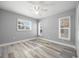 Charming bedroom with plantation shutters and wood-look floors at 525 Madrid Blvd, Punta Gorda, FL 33950
