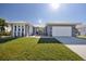 Beautiful house with gray exterior, white trim, and a two-car garage at 525 Madrid Blvd, Punta Gorda, FL 33950