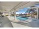 Relaxing pool area with canal views from under the covered patio at 525 Madrid Blvd, Punta Gorda, FL 33950