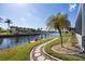 Landscaped walkway to the waterfront with red chairs at 525 Madrid Blvd, Punta Gorda, FL 33950