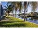 Waterfront property with lush landscaping and canal views at 525 Madrid Blvd, Punta Gorda, FL 33950