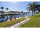 Scenic waterfront view with two red chairs and a stone path at 525 Madrid Blvd, Punta Gorda, FL 33950