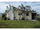 View of the side of a yellow house with a white chimney at 700 W Perry St, Englewood, FL 34223