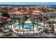 Luxury community pool and clubhouse with palm trees at 87 Vivante Blvd # 8736, Punta Gorda, FL 33950