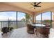 Spacious screened balcony overlooking the water with wicker furniture at 87 Vivante Blvd # 8736, Punta Gorda, FL 33950