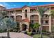 Three-story building with terracotta roof and palm trees at 87 Vivante Blvd # 8736, Punta Gorda, FL 33950