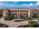 Resort-style building with waterfront views and palm trees at 87 Vivante Blvd # 8736, Punta Gorda, FL 33950