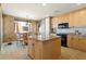Island kitchen with light wood cabinets and granite countertops at 87 Vivante Blvd # 8736, Punta Gorda, FL 33950