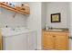 Convenient laundry room with washer, dryer, and extra storage at 87 Vivante Blvd # 8736, Punta Gorda, FL 33950