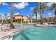 Relaxing community pool with palm trees and lounge chairs at 87 Vivante Blvd # 8736, Punta Gorda, FL 33950