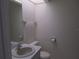 Small bathroom with single sink vanity, toilet, and mirrored medicine cabinet at 1073 Marcus St, Port Charlotte, FL 33952