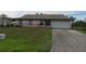 Single story home with attached garage and well maintained lawn at 1073 Marcus St, Port Charlotte, FL 33952